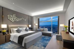 a bedroom with a large bed and a large window at Ascott Xiangjiang FFC Changsha in Changsha +21 photos