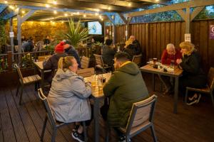 a group of people sitting at tables in a restaurant at The Bank in Anstruther