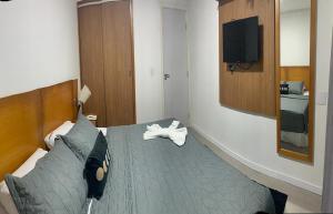 a bedroom with a bed and a tv on a wall at Ponta Negra Beach Luxury in Natal +22 photos