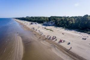 an overhead view of a beach with a group of people at Skolas street seaside space! in Jūrmala +3 photos