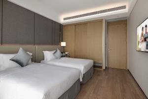 Postelja oz. postelje v sobi nastanitve Ascott Xiangjiang FFC Changsha