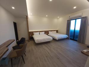 Postel nebo postele na pokoji v ubytování Blue Sea Stone Homestay + 5 fotografií