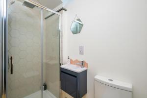 a bathroom with a shower and a sink and a toilet at Cart Shed Cottage in Truro +30 photos
