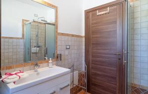 a bathroom with a sink and a wooden door at TRE BORGHI in San Giovanni a Piro +130 photos