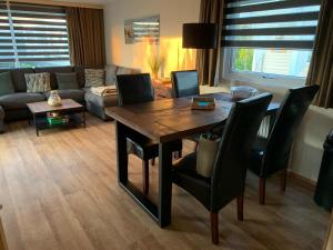 a living room with a table and chairs and a couch at RBR 655 - Beach Resort Kamperland in Kamperland
