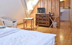 a bedroom with a bed and a desk with a television at Gentner - Hotel garni in Gnotzheim