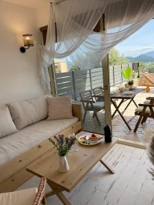 a living room with a couch and a table at En Lefko Boutique Apartments in Nikiana