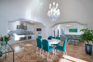 uma cozinha e sala de estar com mesa e cadeiras em Luxury Villa Malika - Great View on Capri&Positano em Praiano
