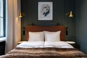 a bedroom with a bed with white pillows at Scandic Grand Central Helsinki in Helsinki