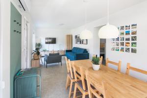 a dining room and living room with a table and chairs at Positive sport apartments in Kobarid