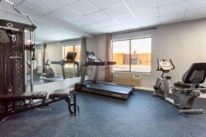 a gym with a treadmill and ellipticals in a room at Baymont by Wyndham Rochester Mayo Clinic Area in Rochester