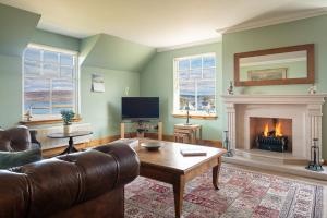 a living room with a couch and a fireplace at Morvern in Tobermory