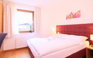 Łóżko lub łóżka w pokoju w obiekcie Chalet Schmittenbach - Pinzgau Holidays