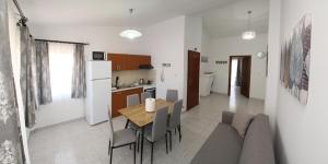 a kitchen and dining room with a table and chairs at Lampias apartments in Keramoti