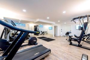 a gym with treadmills and machines in a room at Laudensacks Parkhotel & Retreat in Bad Kissingen