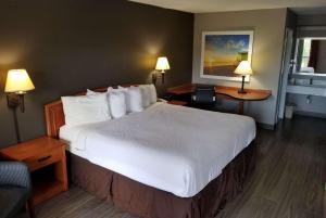 A bed or beds in a room at Days Inn by Wyndham Wilson