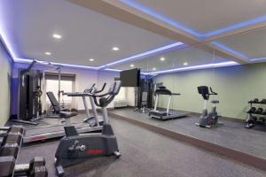 a gym with several tread machines and a mirror at Wingate by Wyndham Murfreesboro-NEAR MTSU in Murfreesboro