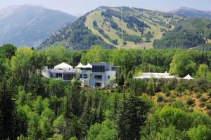a large house in the middle of a forest of trees at Aspen Meadows Resort in Aspen