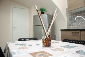 a table with a vase filled with nuts and sticks at Meghan Home in Catania