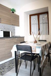 a kitchen with a table and chairs in a kitchen at Meghan Home in Catania
