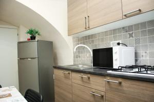 a kitchen with a refrigerator and a microwave at Meghan Home in Catania