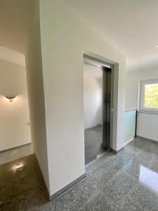 an empty room with a door and a window at Hotel Kosel garni UG in Rust