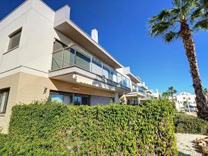 a building with a palm tree in front of it at 3077 Residencia AZAHAR GARDEN in Orihuela