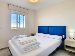 a bedroom with a bed with white sheets and blue headboard at 3071 Res Vista Azul XXIX in Villamartin +16 photos
