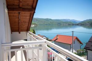 a balcony with a view of a lake at Big Mama's Apartments in Konjic