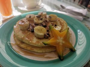 a plate of pancakes with bananas and a star on it at CASA STELLA in Heredia