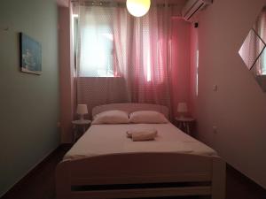 a bed in a room with a red wall at Beautiful house by the sea,Loutraki Skaloma. in Loutraki