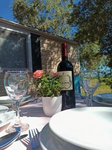 a bottle of wine sitting on a table with glasses at Camping Torkul in Kraj