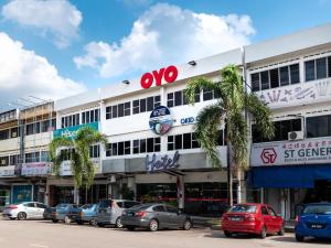 a large building with cars parked in front of it at Okid Hotel in Johor Bahru