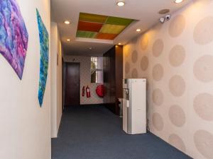 a hallway with a refrigerator in a room at Okid Hotel in Johor Bahru