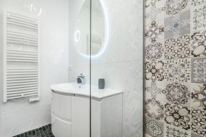 a white bathroom with a sink and a mirror at Maredimo Village Porto Casa 5 in Porto