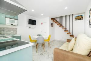 a kitchen and living room with a couch and a table at Maredimo Village Porto Casa 5 in Porto +16 photos