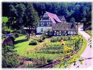 a large house with a garden in front of it at Ferienhof Richard in Lennestadt
