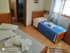 a hotel room with two beds with towels on them at Menelaos Apartments in Lefokastro
