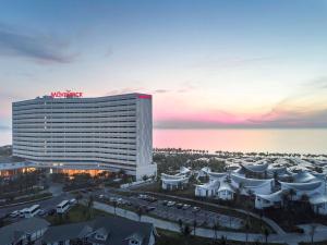 a view of the w hotel at sunset at Mövenpick Resort Cam Ranh in Cam Ranh