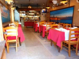 a restaurant with tables and chairs with pink table cloth at Boutique Hotel Melissa in Poreč