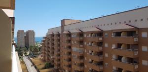 an apartment building with balconies on the side of it at Zona Marina Dor - Apartamentos Costa Caribe II in Oropesa del Mar