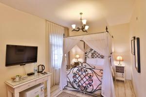a bedroom with a large bed with a canopy at Park Mandalin Hotel - Adult only in Ağva