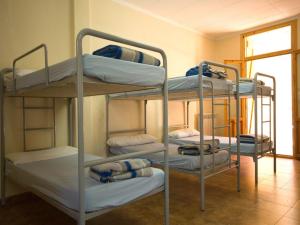 3 Etagenbetten in einem Zimmer mit Fenster in der Unterkunft La Casa de Pineta in Bielsa