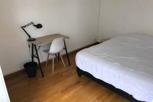 um quarto com uma cama e uma secretária com um candeeiro em Logement 6P BALCON/ MODERNE HYPER CENTRE em Caen