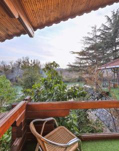 a balcony with a chair and a view of a river at Park Mandalin Hotel - Adult only in Ağva