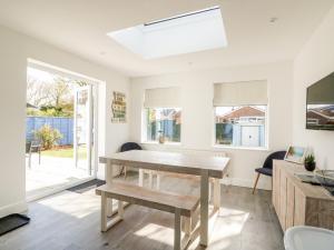 a dining room with a table and a window at The Seaside Retreat in Mablethorpe