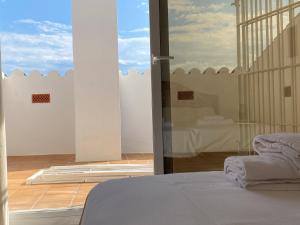 a bedroom with a bed and a large glass window at BLAU Bonito Duplex con Terraza in Calella de Palafrugell