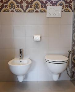 a bathroom with a toilet and a sink at Masseria Signora Cecca in Fasano