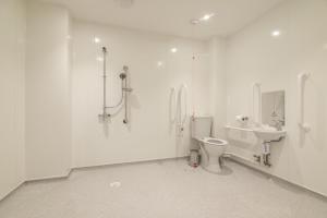 a white bathroom with a toilet and a sink at No 3 Ocean Cabins Bunk Bed - Saundersfoot Harbour in Saundersfoot