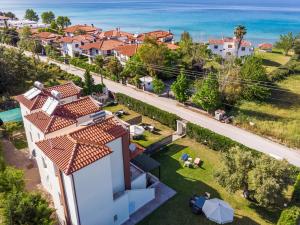 an aerial view of a house with a view of the ocean at Pigadaki Villas Polychrono in Polychrono